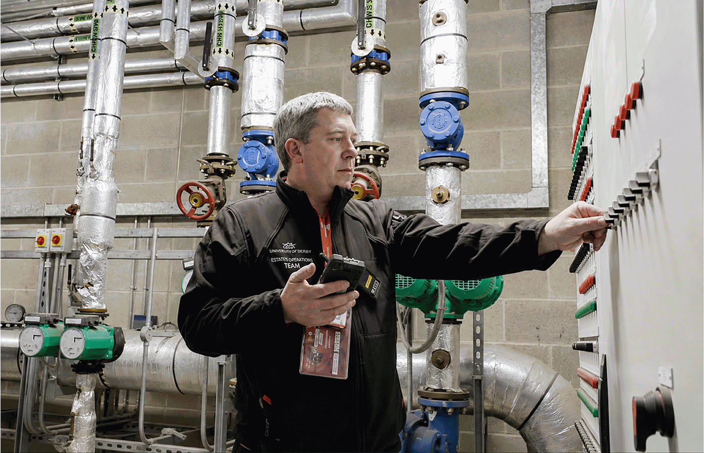 Engineer verifying plant-room equipment on site